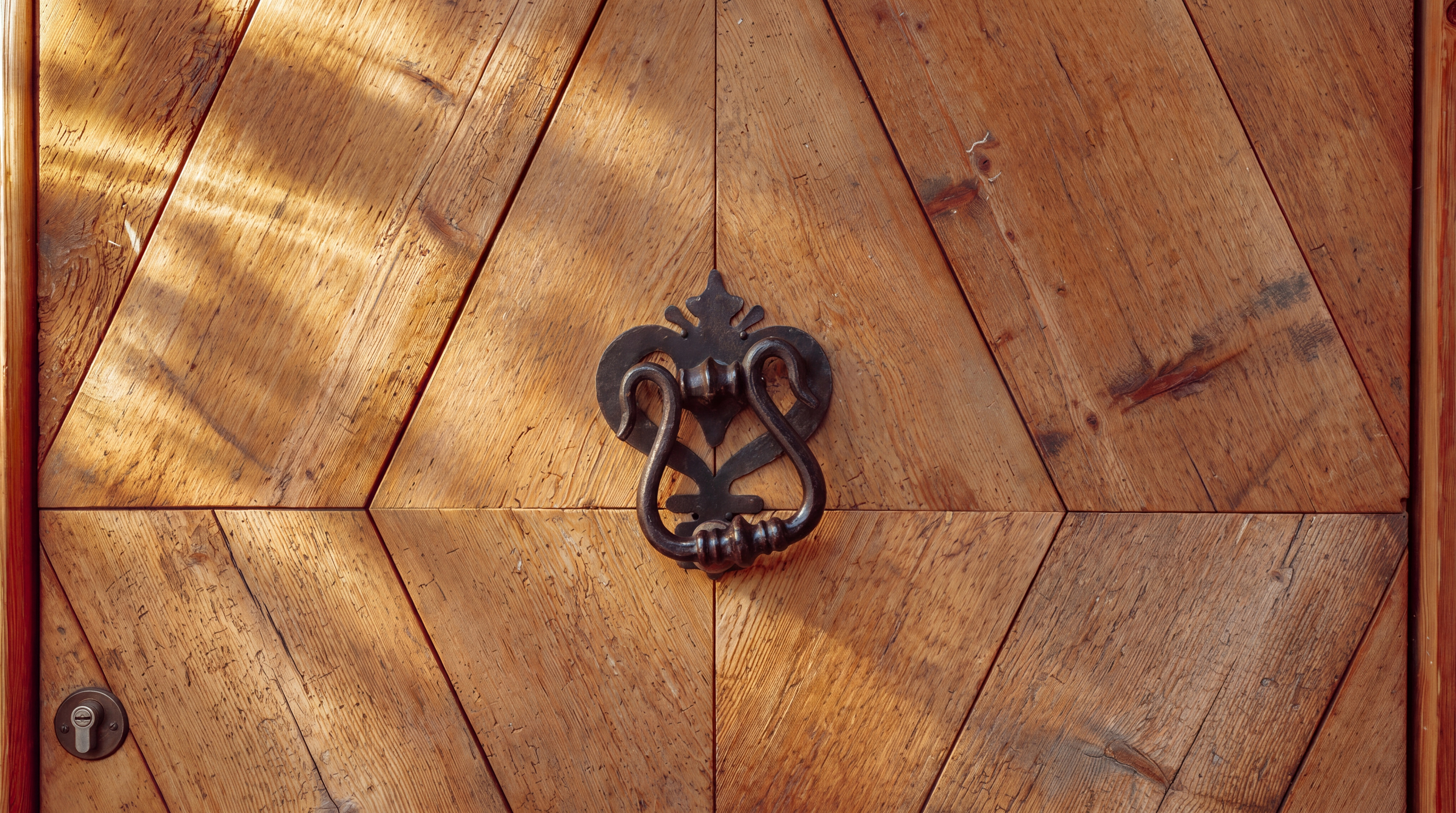 Carved wooden door with wrought-iron knocker