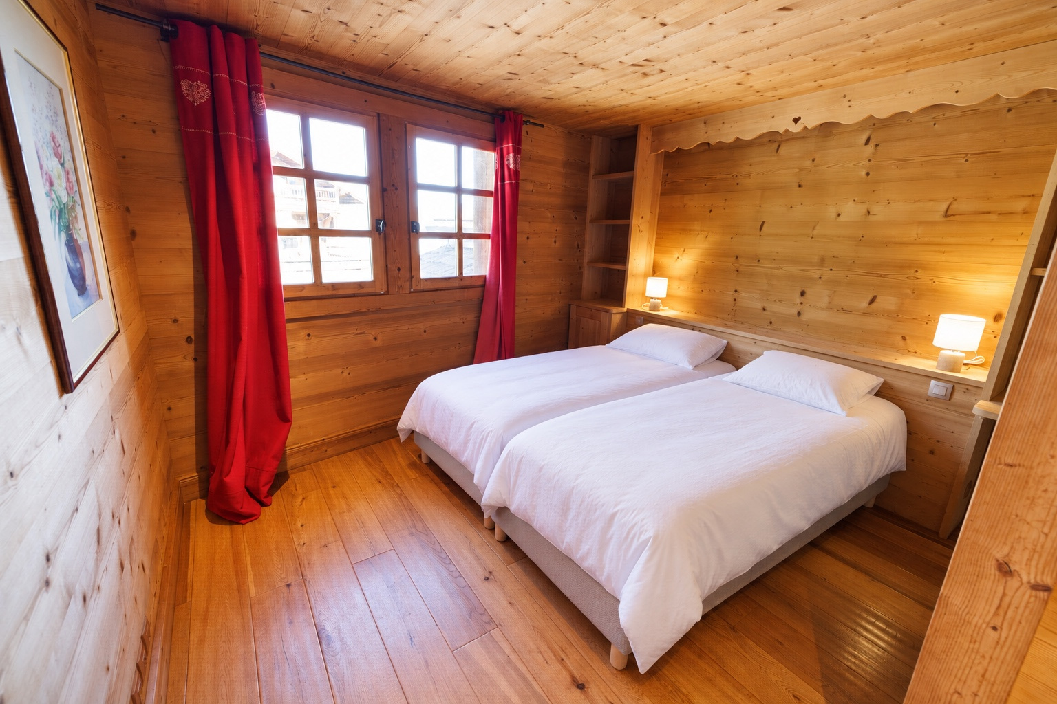 Bedroom with twin beds and red curtains