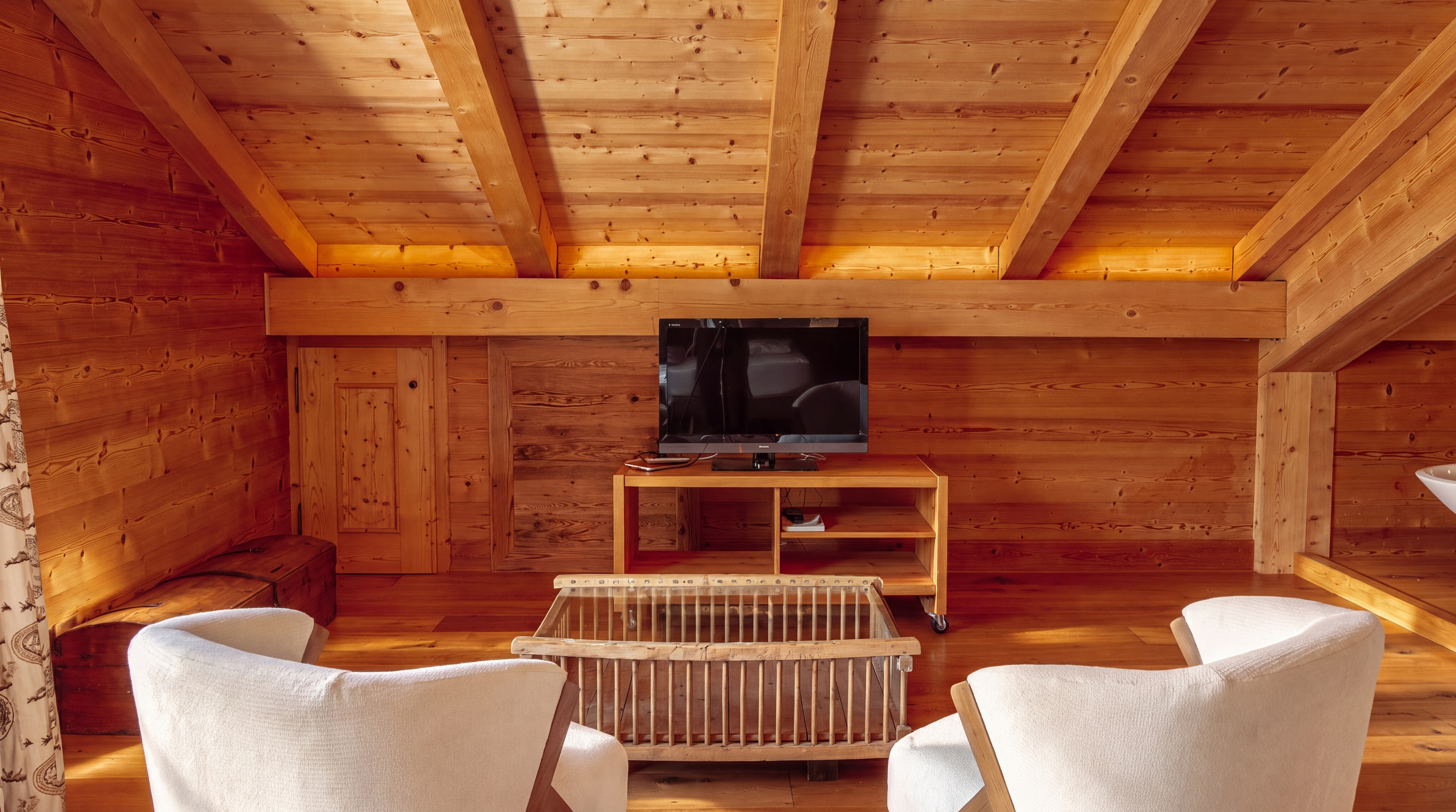 Principal suite seating area with television