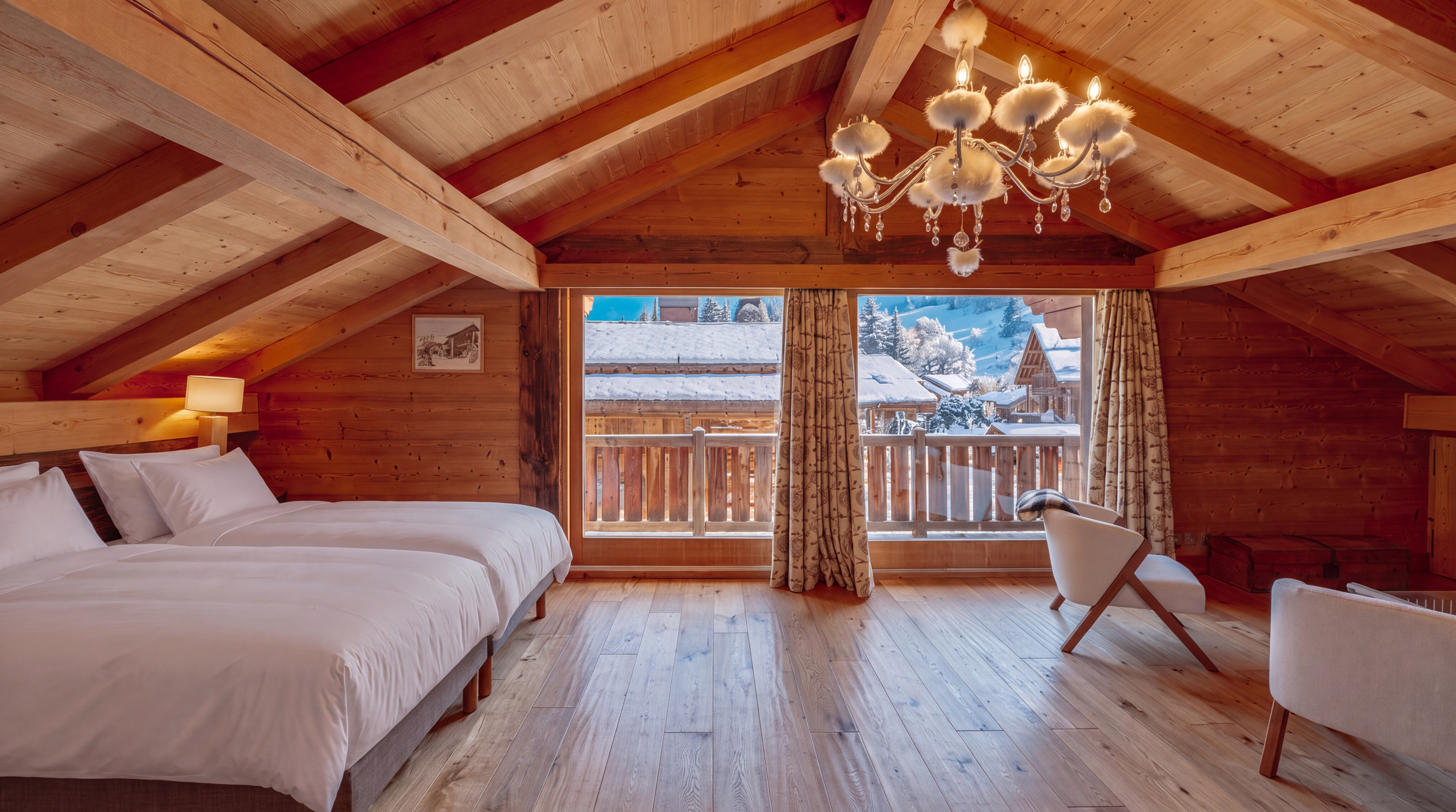 Principal bedroom with chandelier and balcony window