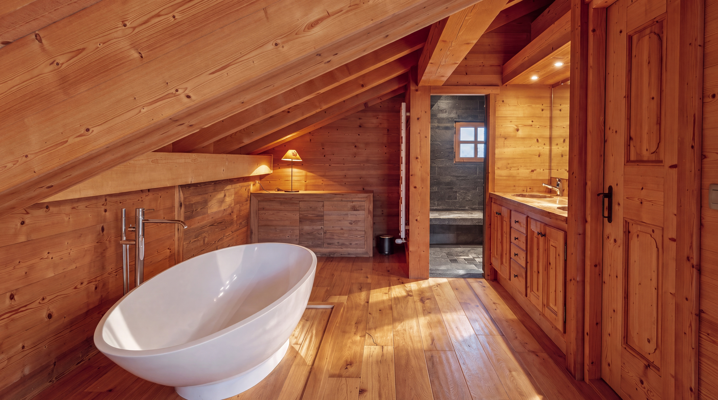 Freestanding bathtub and wooden vanity in the principal suite