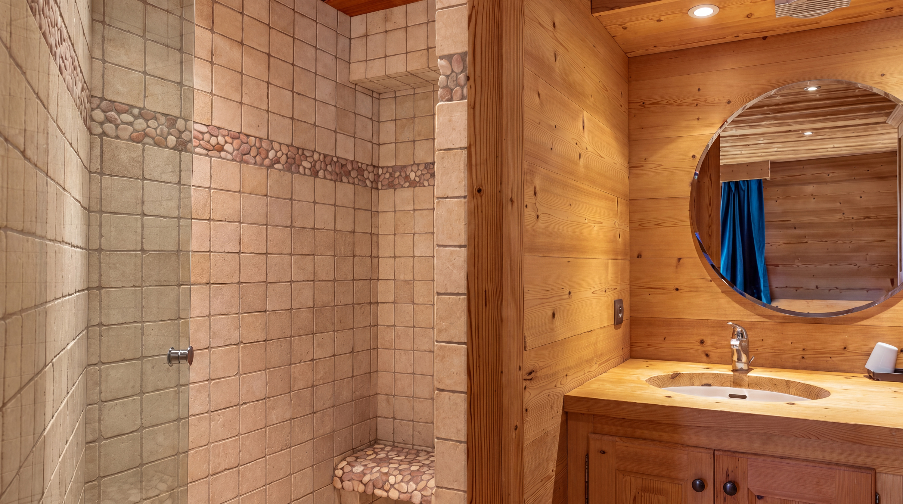 Tiled shower and washbasin with round mirror