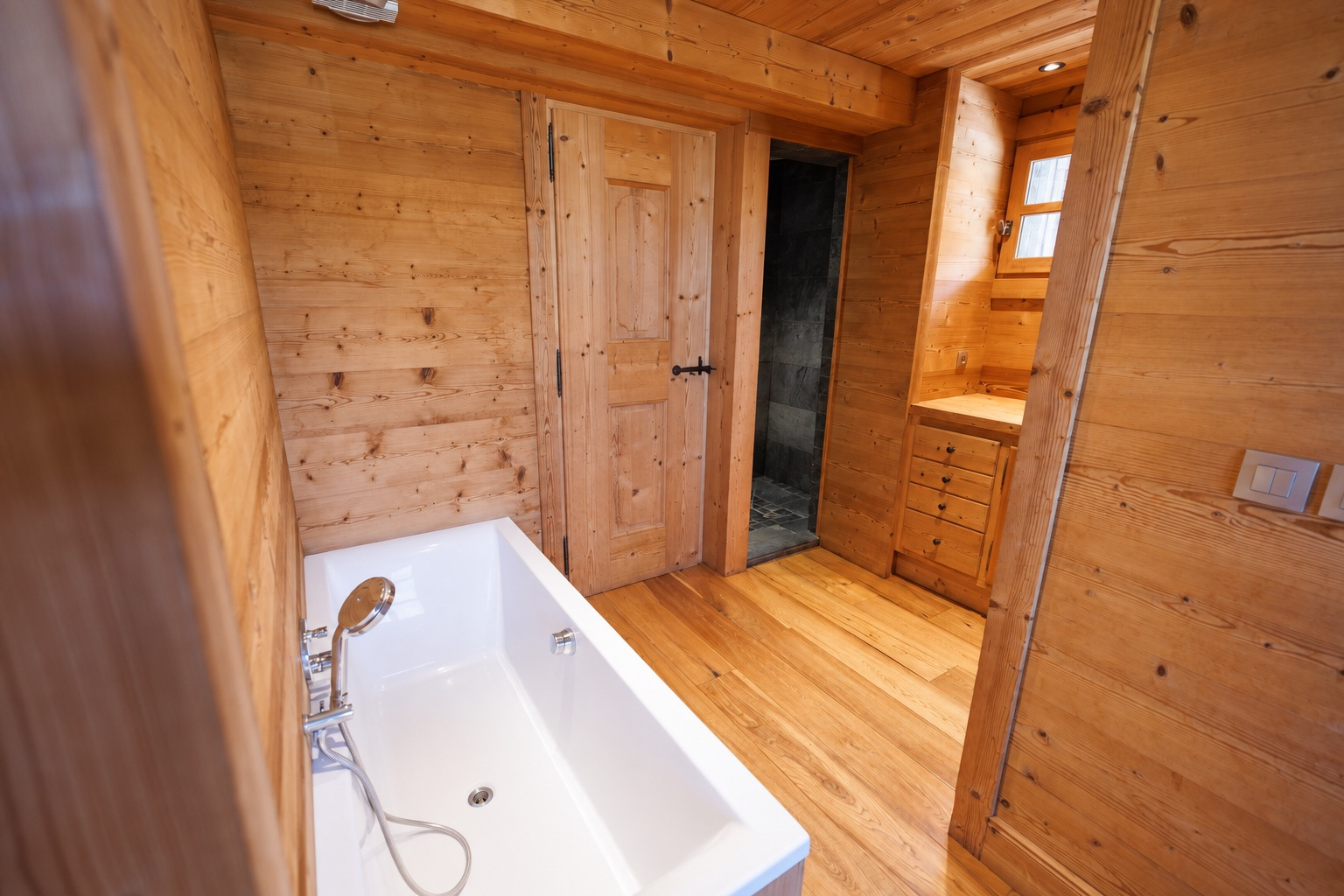 Bathroom with bathtub and wood panelling