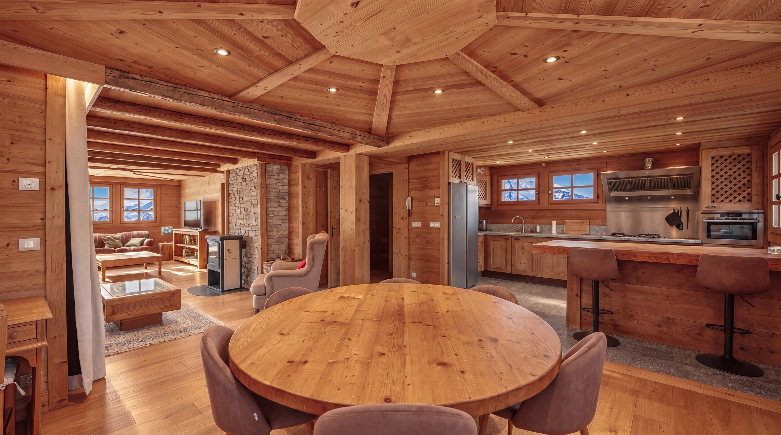 Dining table facing the open kitchen and living area
