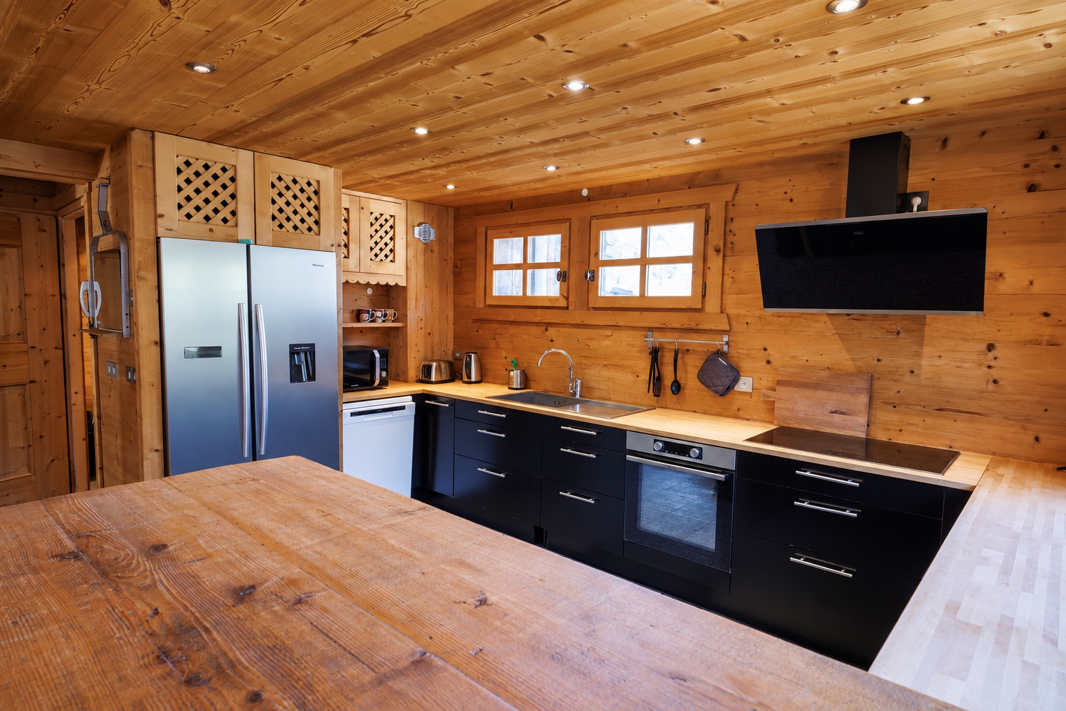 Kitchen seen from the wooden dining table